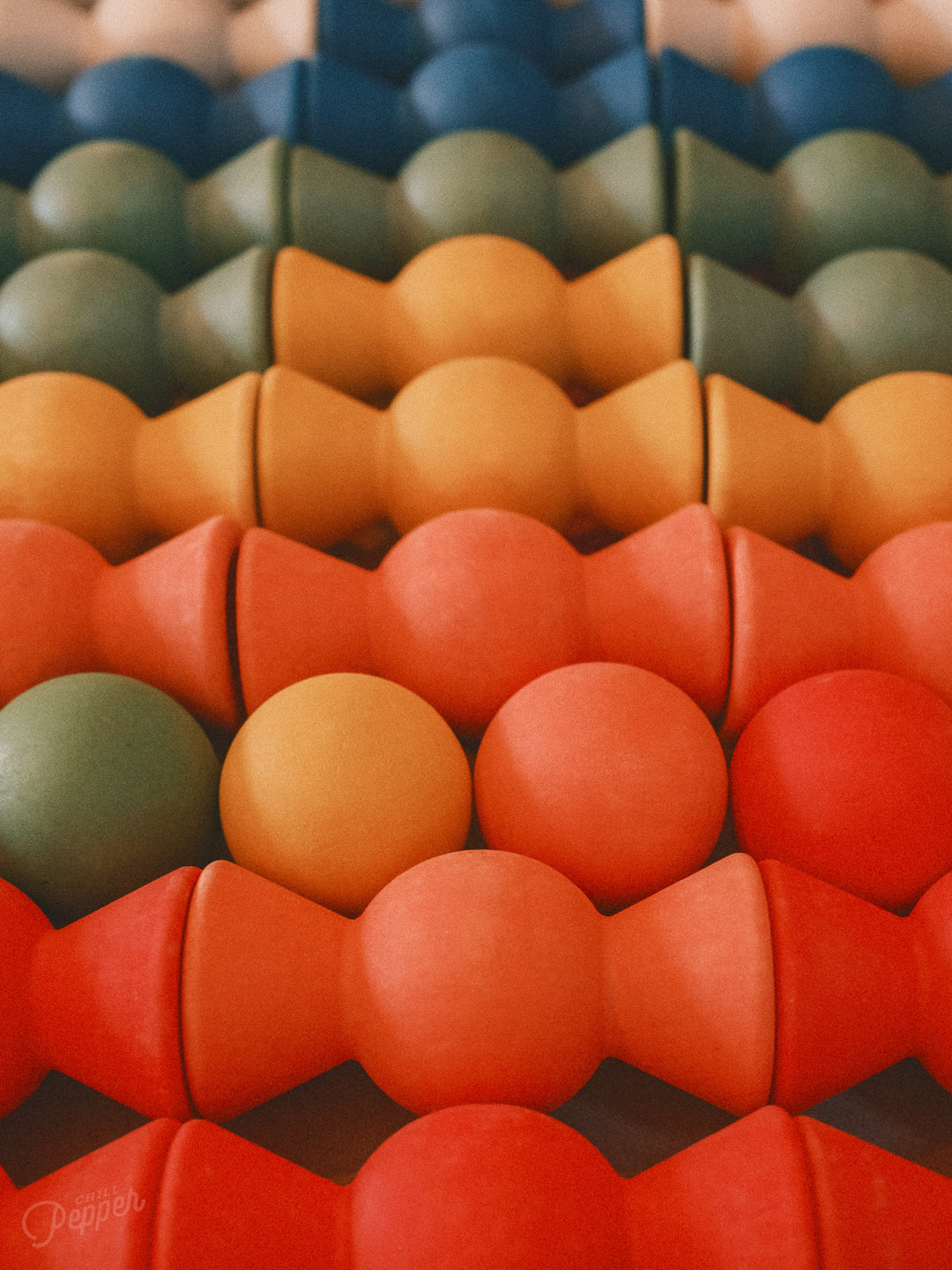 Close-up of Chill Pepper Sweets Forest Fruits wooden sweets and gumballs in colourful rows.