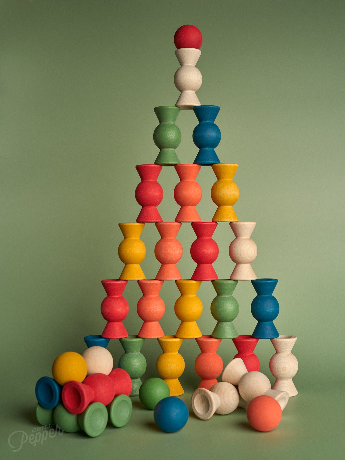 Chill Pepper Sweets Forest Fruits wooden pieces stacked in a tall pyramid, with loose sweets and gumballs at the base.