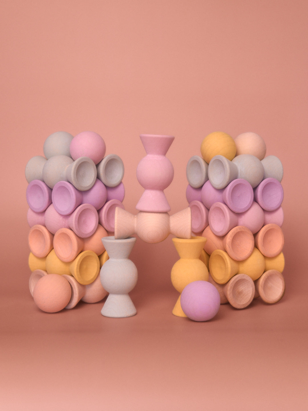 Chill Pepper Sweets Peachy Pastels wooden pieces arranged in two matching stacks with gumballs balanced between them.