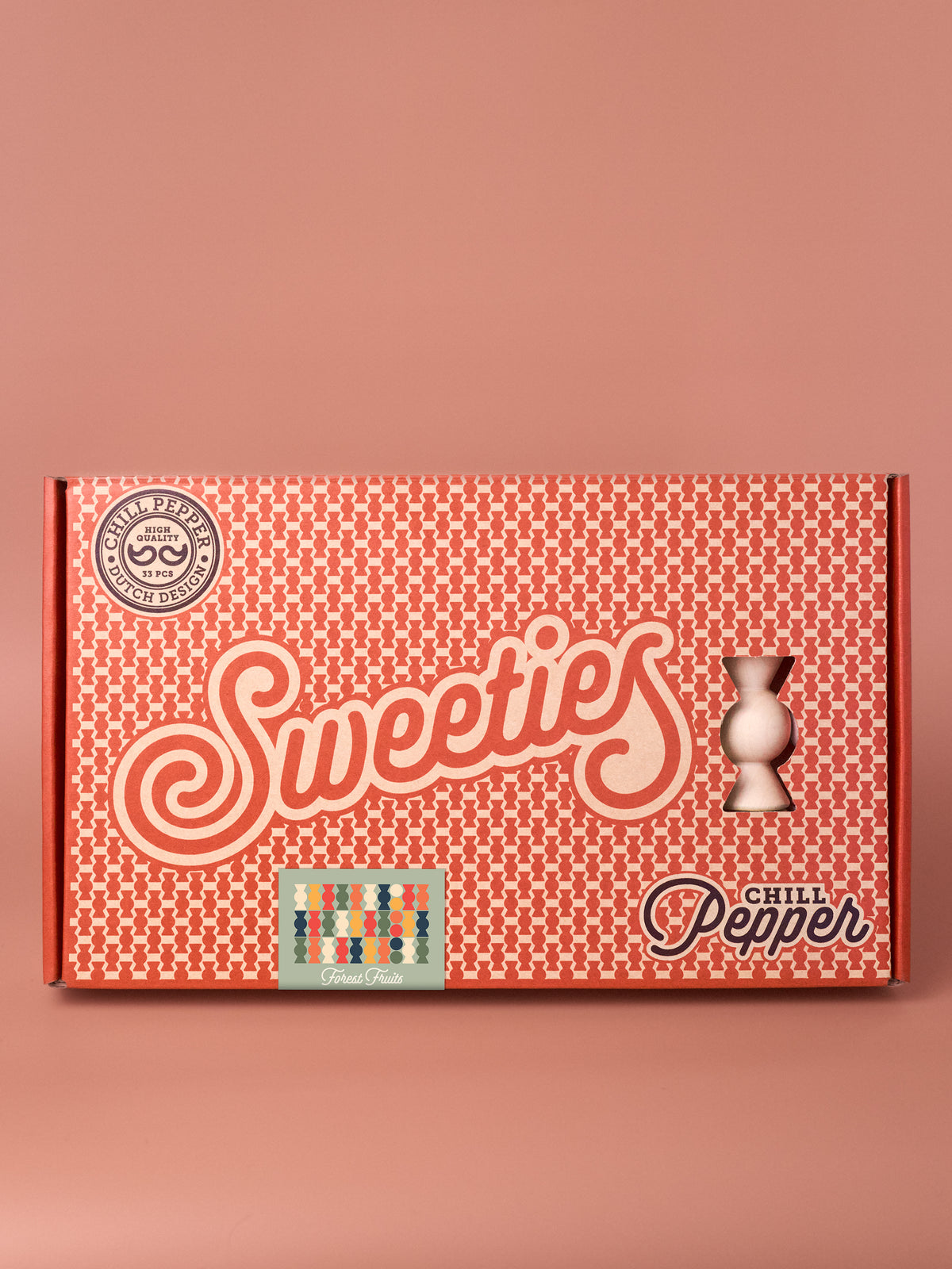 Chill Pepper Sweets Forest Fruits stacking game in its patterned box on a pink background.