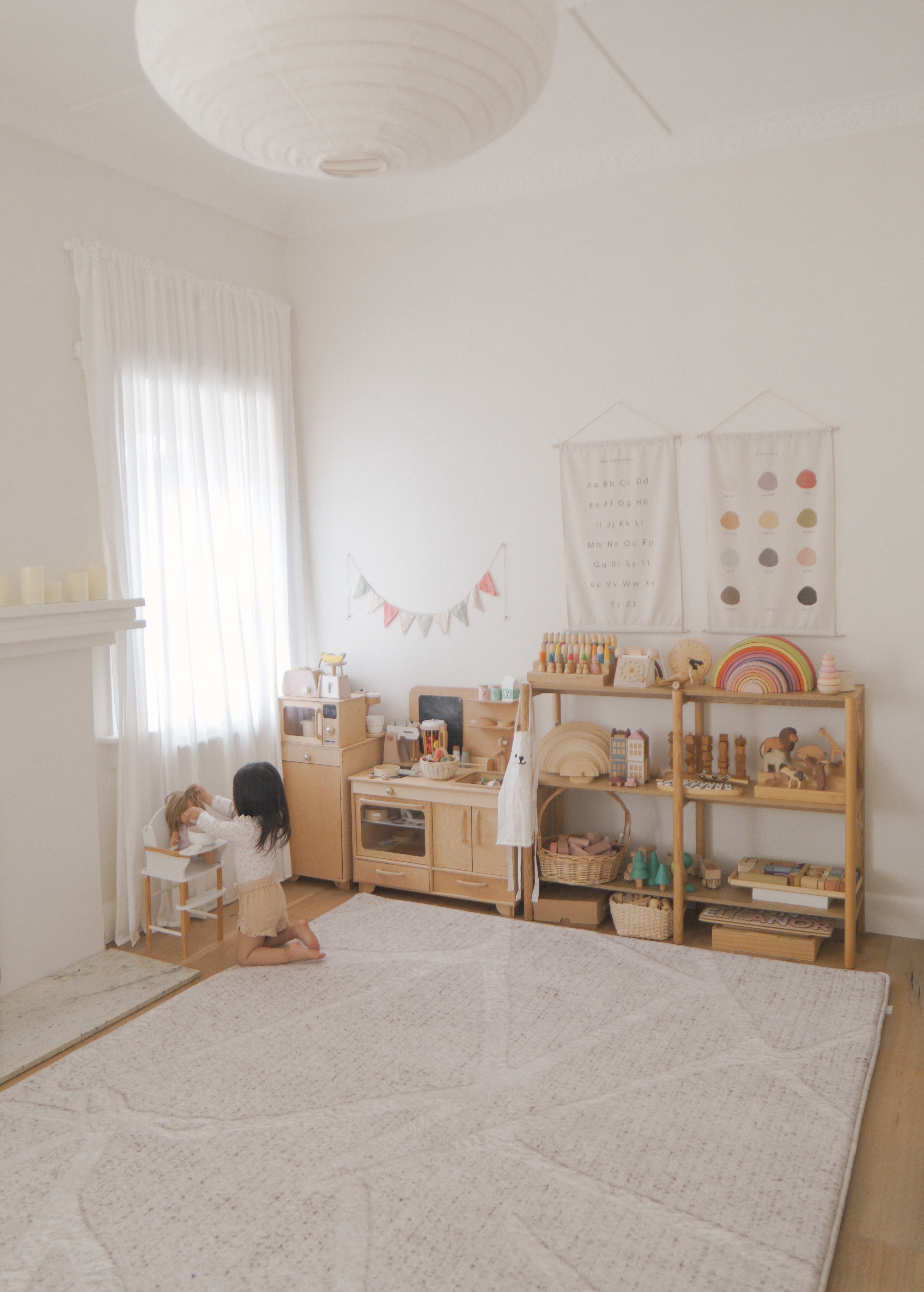 Child playing on Little Wiwa cushioned play rug at home
