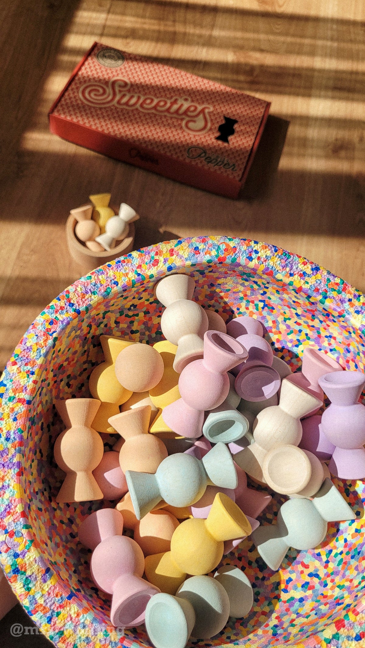 Writing


Chill Pepper Sweets Peachy Pastels wooden pieces in a colourful speckled bowl, with their patterned box on the sunlit floor behind.
