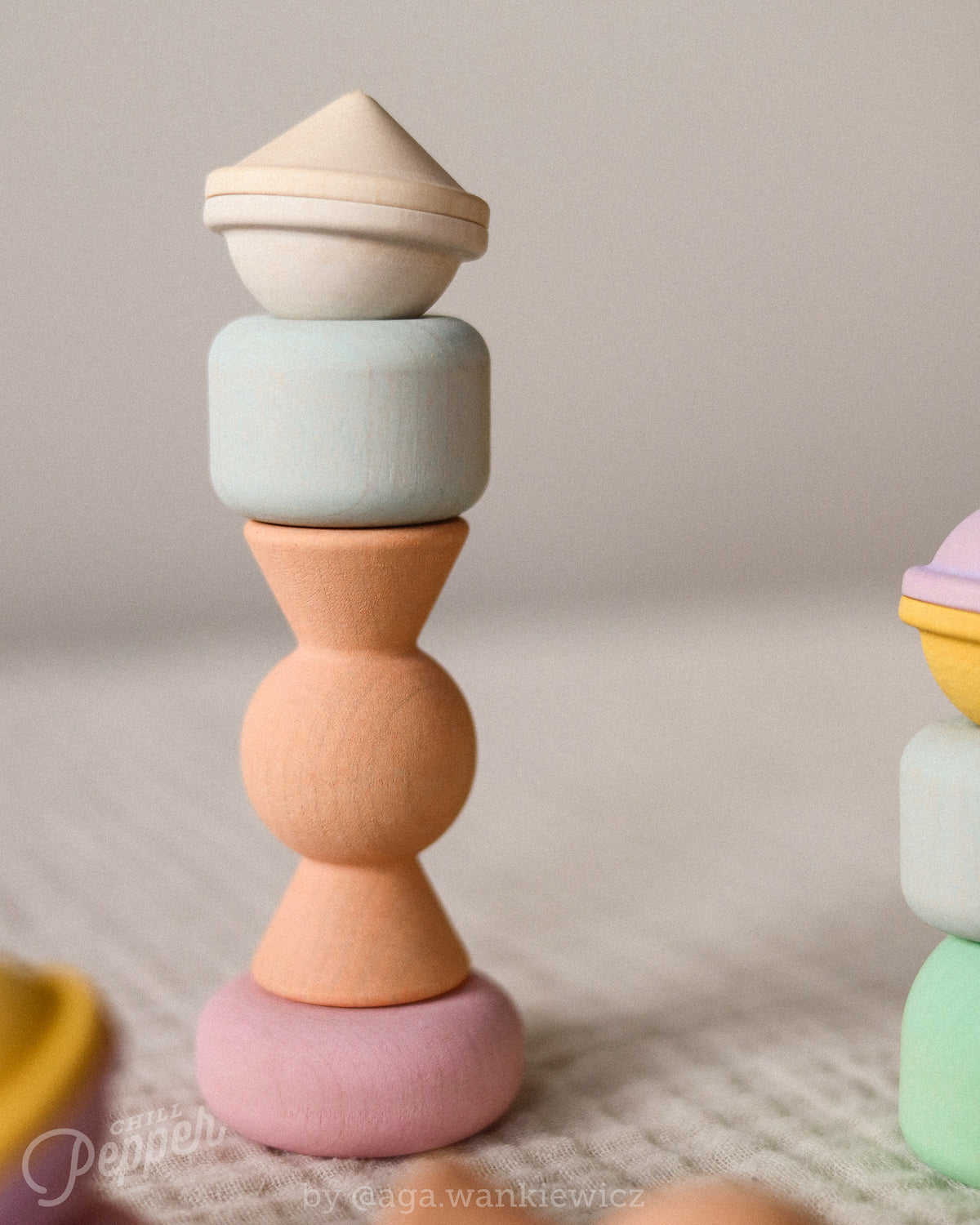 Writing


Chill Pepper Treats wooden pieces stacked in a tower, with a pink ring base, peach sweet shape, pale blue block and natural wood top.