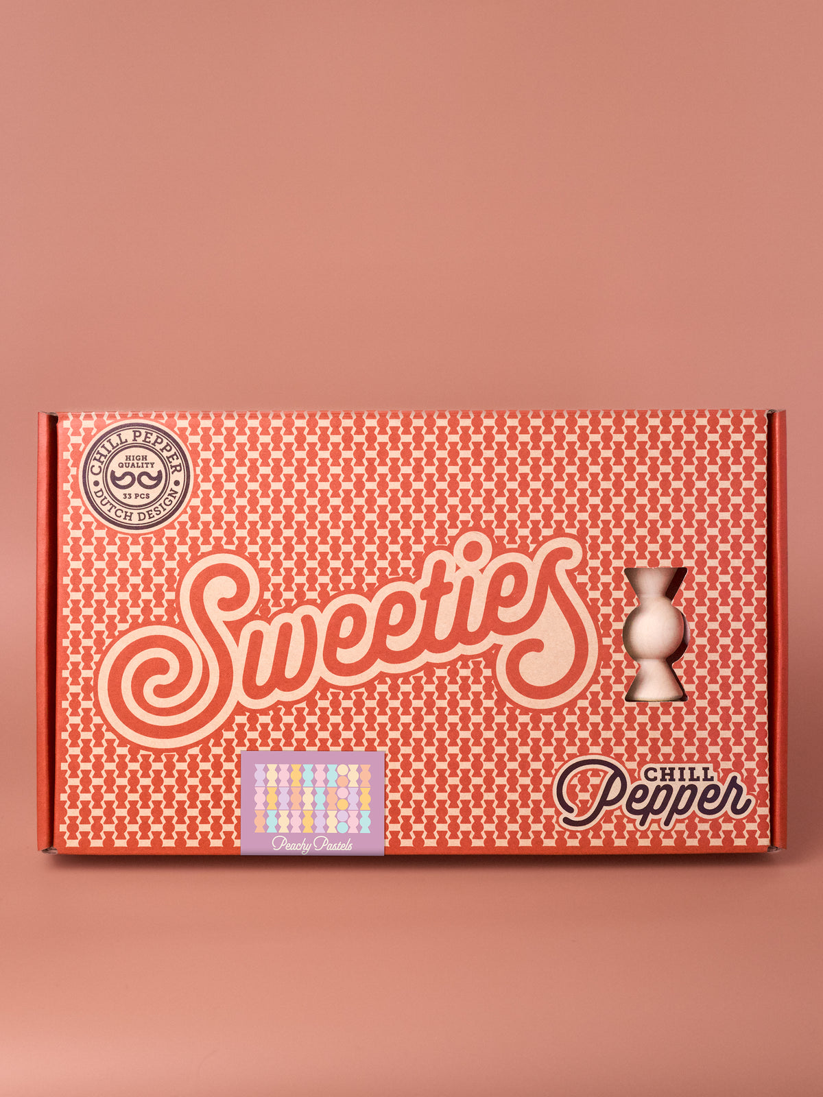 Chill Pepper Sweets Peachy Pastels wooden stacking game in its patterned box on a pink background.