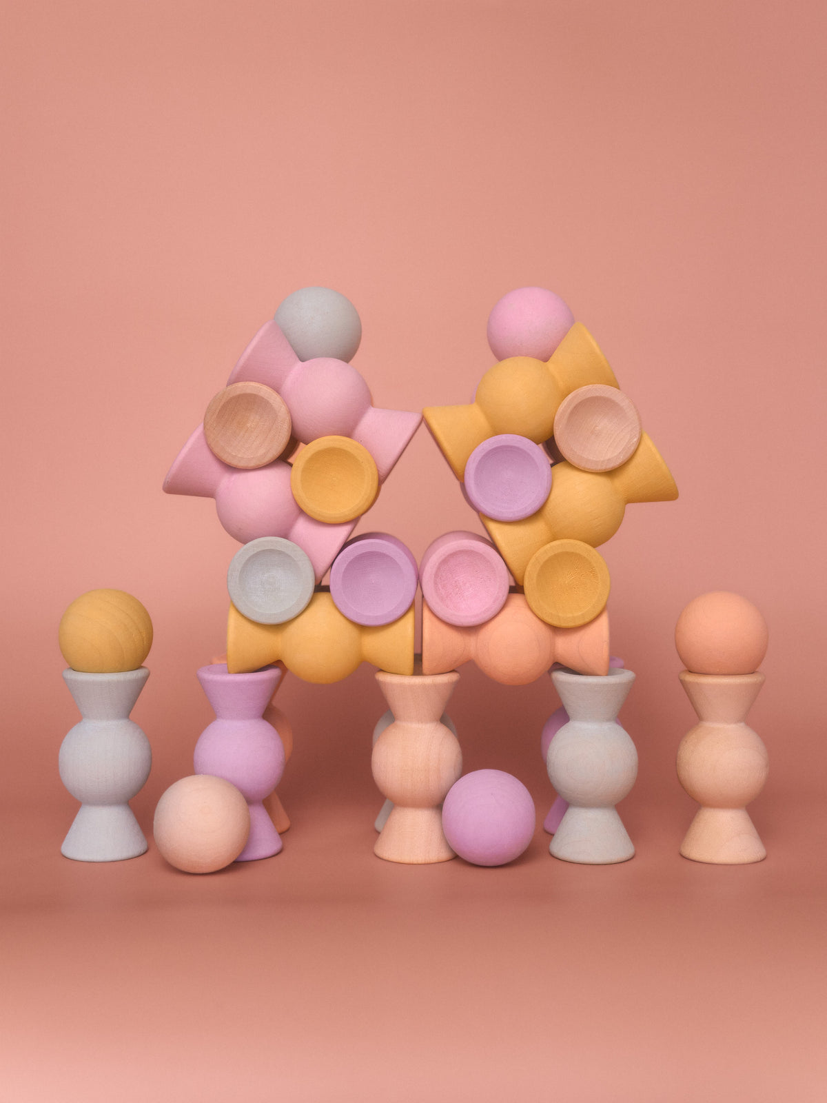 Chill Pepper Sweets Peachy Pastels wooden pieces stacked in a wide branching tower with gumballs balanced on top.