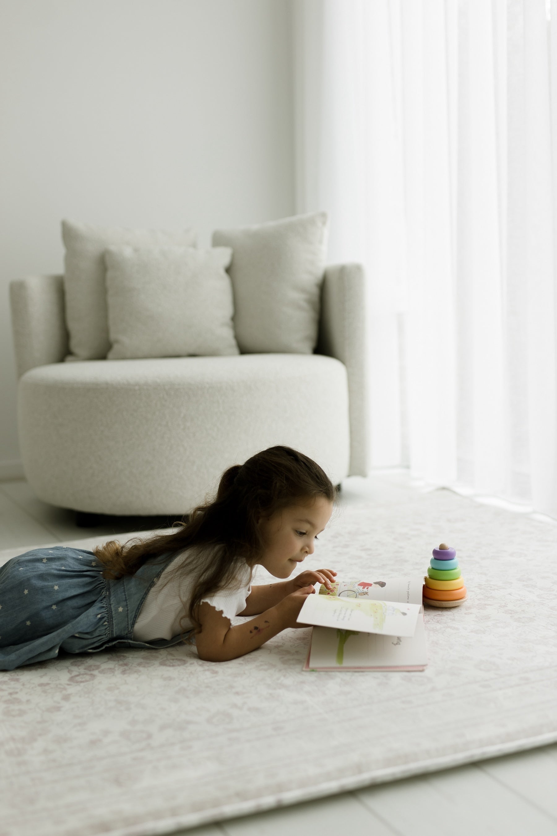 Child playing on Little Wiwa cushioned play rug at home